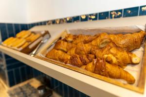 a bunch of pastries on a shelf in a bakery at Travelodge Barcelona Poblenou in Barcelona