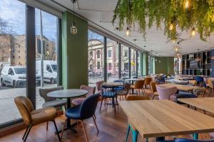 a restaurant with tables and chairs and windows at Travelodge Barcelona Poblenou in Barcelona