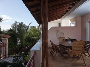 a patio with a table and chairs on a balcony at Evi's Voula Home in Athens