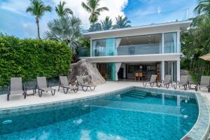 a house with a swimming pool next to a house at Villa Tiwera 6br Private Pool & Sea View in Chaweng Noi Beach