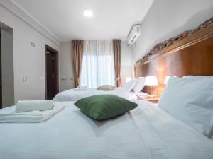 Postel nebo postele na pokoji v ubytování Hotel Perun