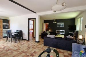 a living room with a couch and a table at Home from home in Le Haut-Corlay