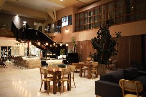 a lobby with tables and chairs and a restaurant at Garden Hotel Boutique & Events in Haifa