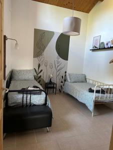 a bedroom with two beds and a couch in it at Casale di Maro in Monte Giberto