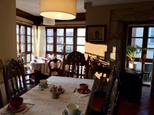 a dining room with a table and chairs and a dining room at Posada La Casona De Ucieda in Ucieda de Arriba