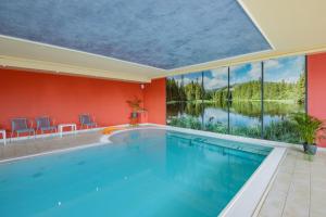 a swimming pool in a house with a large window at Ferien Residenz Thüringer Wald in Masserberg