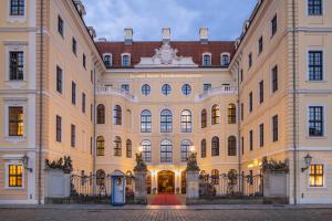 a large tan building with a large building at Hotel Taschenbergpalais Kempinski in Dresden