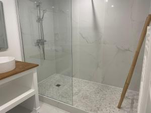 a shower with a glass door in a bathroom at Studio Les Hauteurs de Juziers in Juziers +9 photos