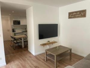 a living room with a flat screen tv on a wall at Studio Les Hauteurs de Juziers in Juziers