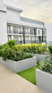 a white building with plants in front of it at Elite Luxury Suites at Loxwood House in Accra