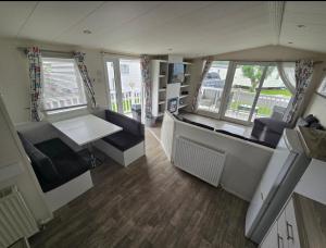 a room with a kitchen and a living room at Lyons robin hood lodge Rhyl in Rhyl
