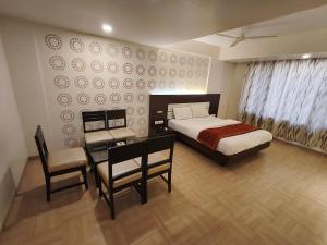 Krevet ili kreveti u jedinici u objektu Hotel Vijay Sagar Dombivali