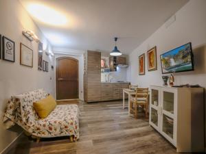 a living room with a couch and a kitchen at Waterfall Vicolo V in Isola del Liri