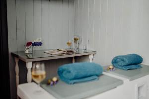 a table with two blue pillows and a glass at Cuore 46&48 by Travel with Gianni in Monopoli +36 photos