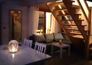 a living room with a couch and a table at Domki na Mazurach - Rybical 65 in Ryn