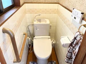 a bathroom with a toilet and a sink at Villa Hineno in Izumi-Sano +27 photos