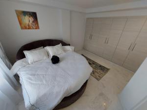 a bed with a black cat sitting on top of it at Luxury marsa beach in La Marsa