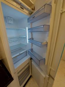 a refrigerator with its door open with its shelves at Luxury marsa beach in La Marsa +7 photos