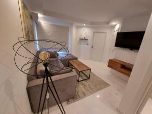 a living room with a couch and a television at Luxury marsa beach in La Marsa