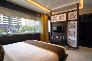 Ένα ή περισσότερα κρεβάτια σε δωμάτιο στο Open Hotel by Olive - JK Residency