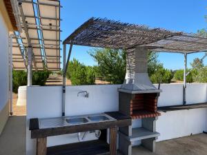 a outdoor grill on the back of a house at Monte Açores in Ferreira do Alentejo