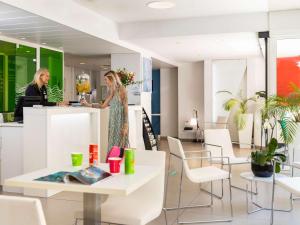 two women standing at a counter in a store at Ibis Styles Menton Centre in Menton