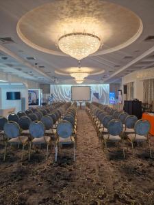 a room with a bunch of chairs and a projection screen at Best Lido Hotel in Timişoara