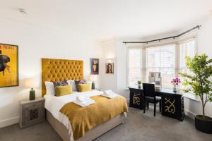 a bedroom with a king sized bed and a desk at Judges Lodgings Boutique Hotel Apartments in Gloucester +20 photos