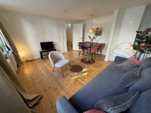 a living room with a blue couch and a table at Kattesundet Apartments Best Location in Copenhagen in Copenhagen +54 photos
