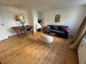 a living room with a couch and a table at Kattesundet Apartments Best Location in Copenhagen in Copenhagen