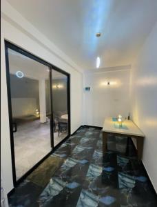 a room with a table and a large glass window at The Ocean Deck Apartments in Moragalla