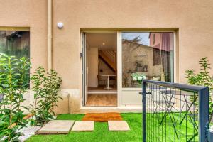 een open deur van een huis met een tuin bij L’Epicéa - RDJ duplex proche métrohôpital in Oullins +32 foto's