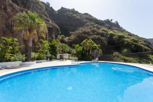 a large swimming pool with a mountain in the background at Ocean Panorama in Puntillo del Sol +13 photos