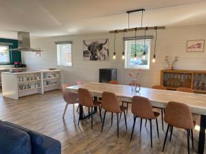 a living room with a large wooden table and chairs at Maison à l'Aise in Durbuy