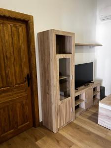 a wooden cabinet with a television in a room at Pósito de Don Juan in Fuente Victoria