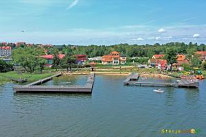 a large body of water with a group of people in a boat at Obiekt Wakacyjny Rejs in Mikołajki