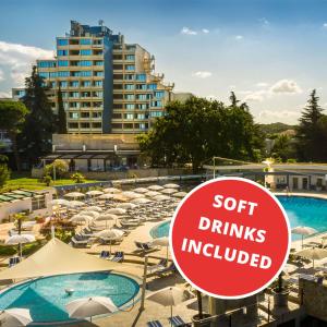 a sign in front of a hotel with chairs and umbrellas at Valamar Diamant Hotel in Poreč