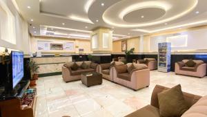 a lobby with couches and a tv in a hospital at رفاد بلس للشقق المخدومة خميس مشيط - REFAD PLUS Khamis Mushait in Khamis Mushayt