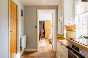 a kitchen with a sink and a counter top at The Old Abbey Farmhouse - Stay at Quarr Abbey Monastery - Pet-Friendly Farmhouse with History & Countryside Views, surrounded by woodland & nature in Ryde +51 photos