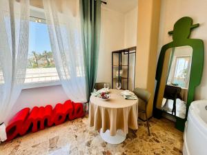 a small table in a room with a window at New Seaside Suite AMORE in Bordighera