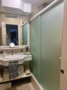 a bathroom with a sink and a glass shower at Casa de categoría para 6 personas in Santiago del Estero +8 photos