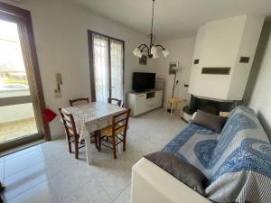 a living room with a couch and a table at La casa di Gabry in Vada
