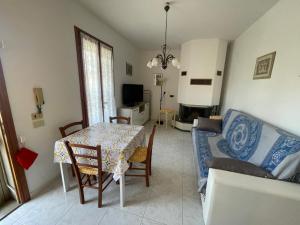 a living room with a table and a couch at La casa di Gabry in Vada
