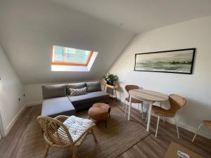 a living room with a couch and a table and chairs at YBH Villa Valentina - Apartamentos Turísticos in Vilagarcia de Arousa