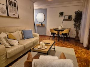 a living room with a couch and a table at 655A El Rincon del Riego in Oviedo