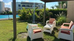 a group of chairs sitting next to a pool at exm55شاليه دايركت على الاجون مراسى الساحل chalet with perfect view lagoon marassi blanca in El Alamein