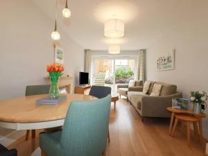 a living room with a table and a couch at Luxury 3-Bed house, Beach 300m, Sleeps 6, Parking in Newquay