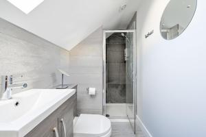 a bathroom with a toilet and a sink and a shower at Luxury 3-Bed house, Beach 300m, Sleeps 6, Parking in Newquay +16 photos