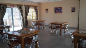 a classroom with tables and chairs in a room at Steps Accommodation in Gobabis