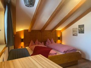 a bedroom with a bed with red pillows on it at Landhaus Elisabeth in Krün